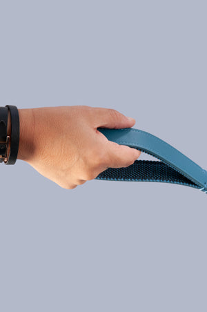 hand holding blue vegan leather dog lead by the handle