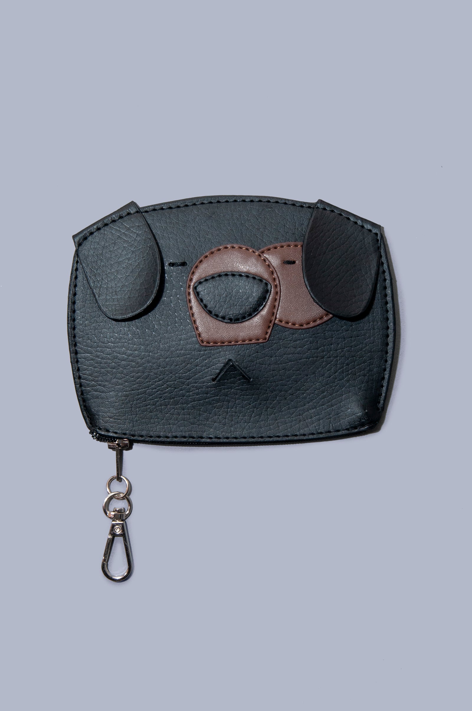 Front view of Boboli poo bag holder. Cute dog face shaped poo waste bag holder with dispenser hole at the mouth position on the front. Gold clasp doubles as wide zip feature at bottom of the bag holder