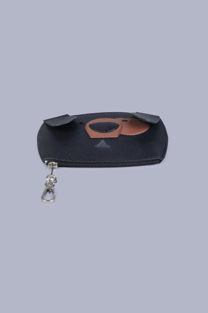 bottom  view of Boboli poo bag holder, demonstrating slim profile.  Cute dog face shaped poo waste bag holder with dispenser hole at the mouth position on the front. Gold clasp doubles as wide zip feature at bottom of the bag holder